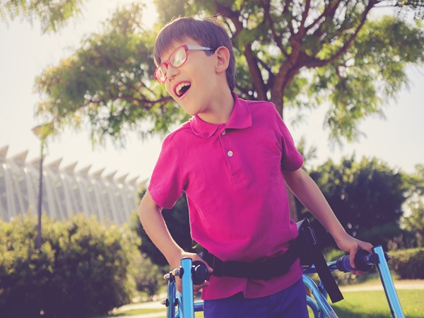 Disability child, walking sticks, cerebral palsy, smiling
